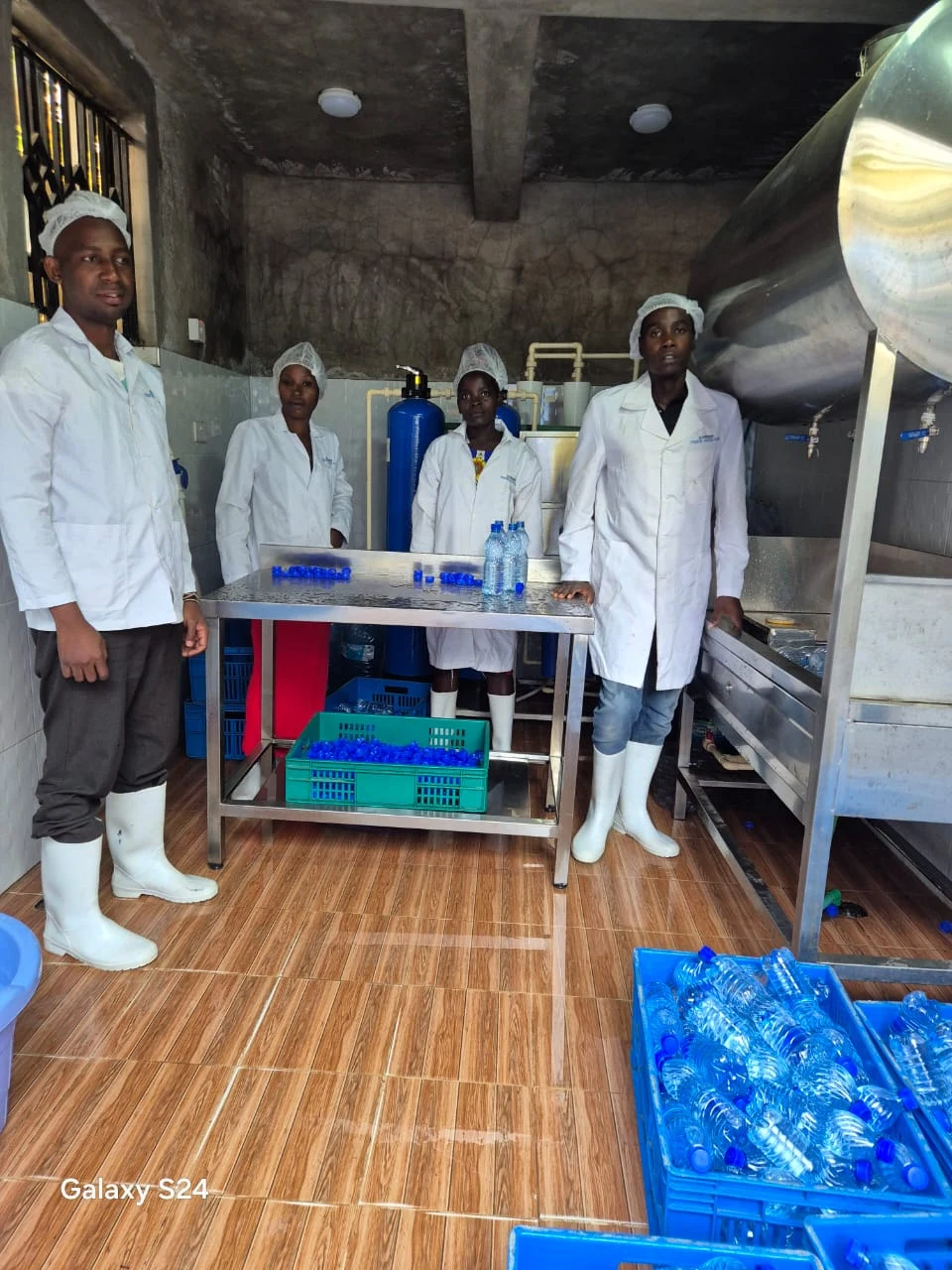 Kapalasa bottling team in protective clothing at the water production facility